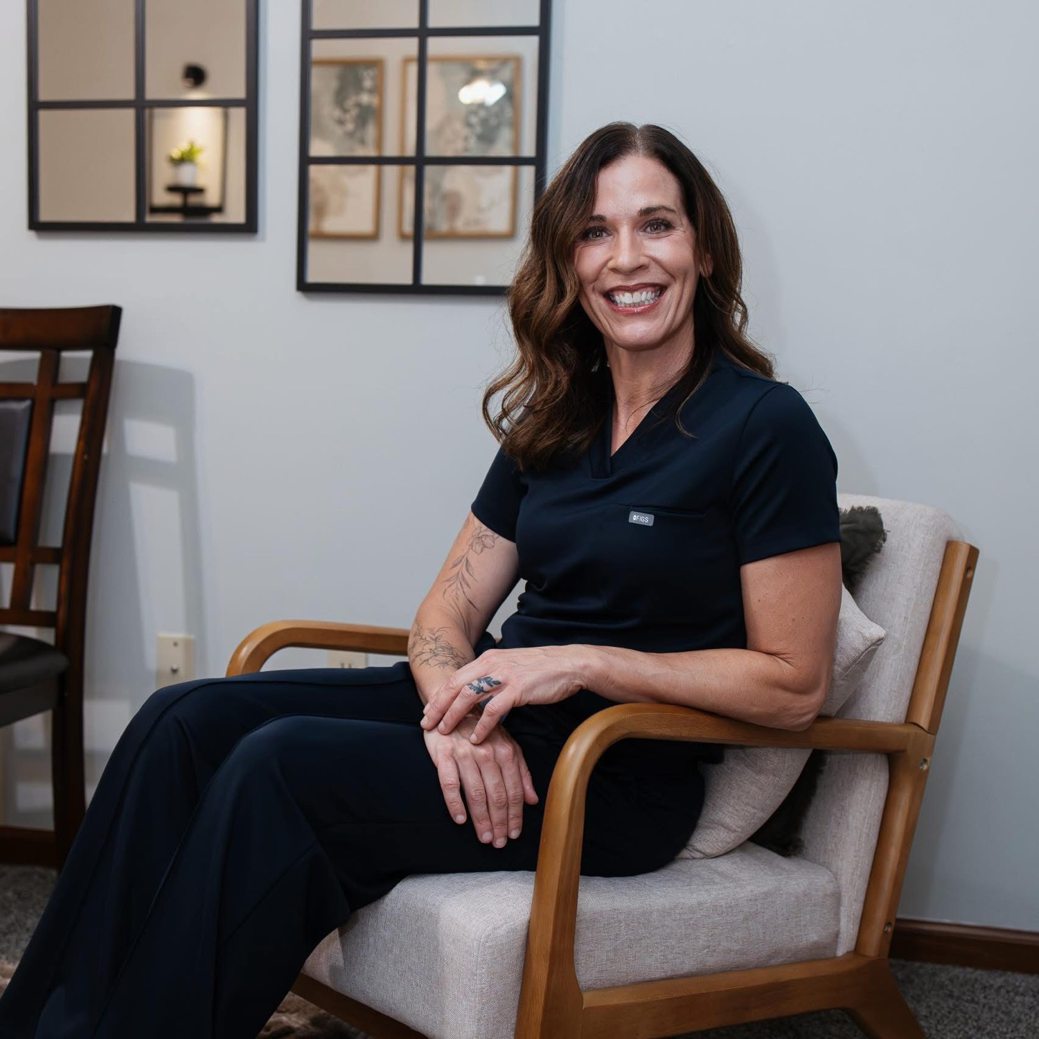 Kathy Hounshell, LMT, MLD, seated in the Precision Therapeutic Massage studio